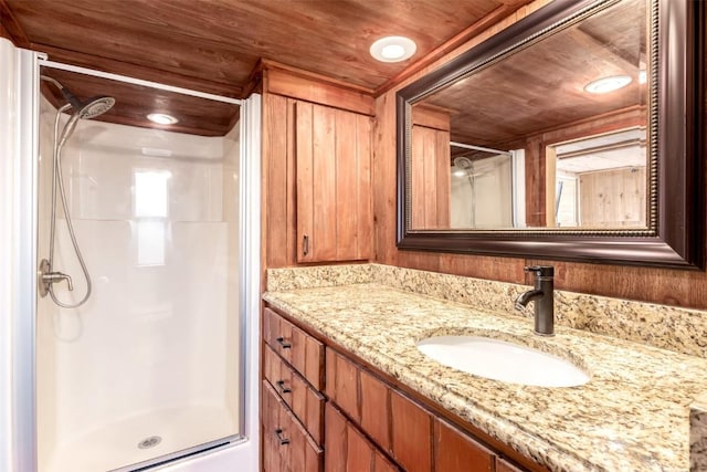bathroom featuring a stall shower and vanity
