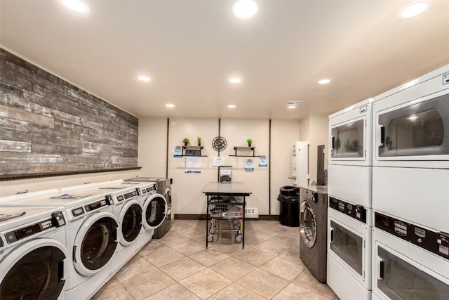 shared laundry featuring stacked washing machine and dryer, recessed lighting, washer and dryer, light tile patterned floors, and baseboards