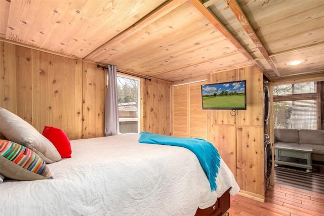 bedroom featuring wooden ceiling, wooden walls, and wood-type flooring
