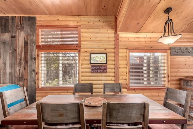 dining space featuring rustic walls and wood ceiling