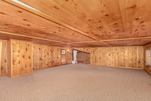 additional living space with wooden ceiling, wood walls, carpet floors, and baseboards