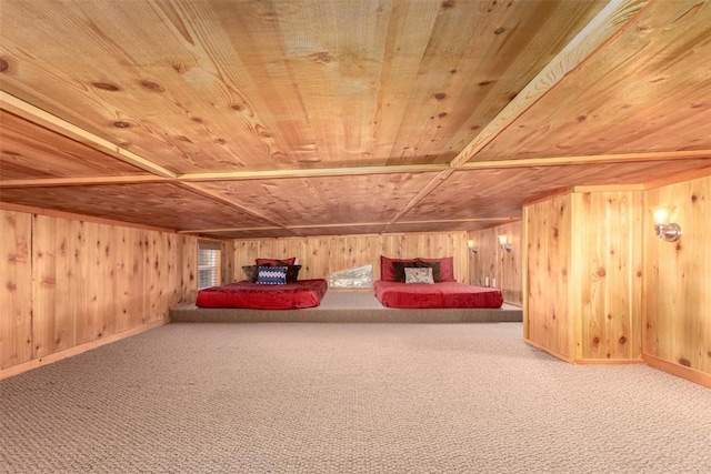 unfurnished bedroom featuring wooden ceiling, wood walls, carpet floors, and baseboards