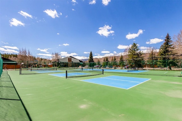 view of tennis court with fence