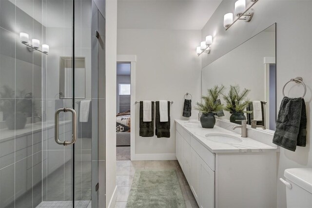 1301 Adams Ave Unit 125, Silverthorne, CO 80498 - bathroom with double vanity, a stall shower, ensuite bath, toilet, and tile patterned flooring