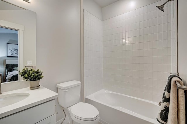 full bath with tub / shower combination, toilet, vanity, and connected bathroom