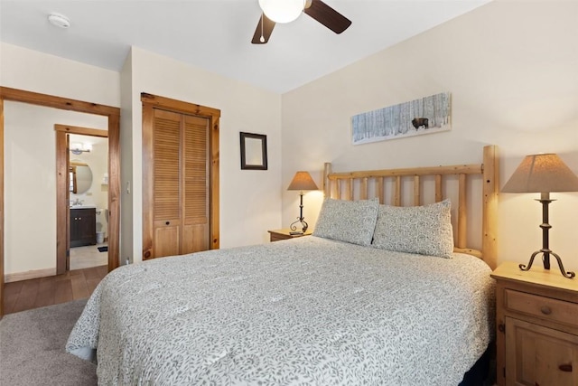 bedroom with wood finished floors, a ceiling fan, a closet, baseboards, and carpet flooring