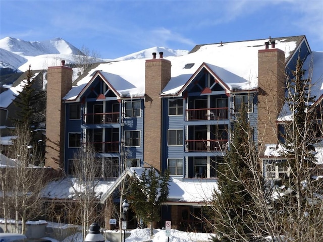 snow covered property featuring a mountain view