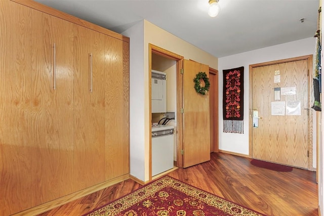 foyer featuring stacked washer / dryer and light wood-type flooring