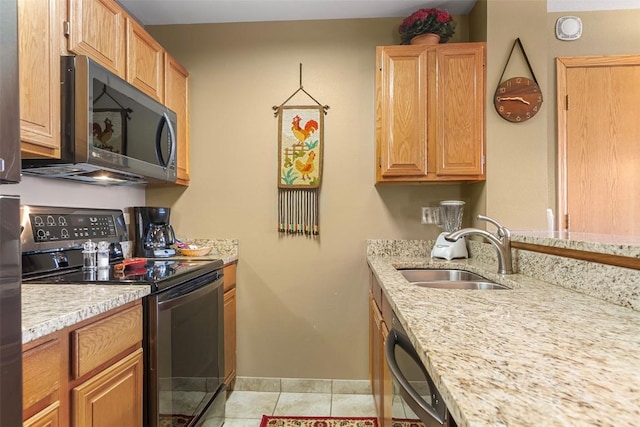 kitchen with light stone countertops, light tile patterned floors, sink, and appliances with stainless steel finishes