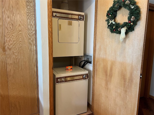 clothes washing area with stacked washer and dryer