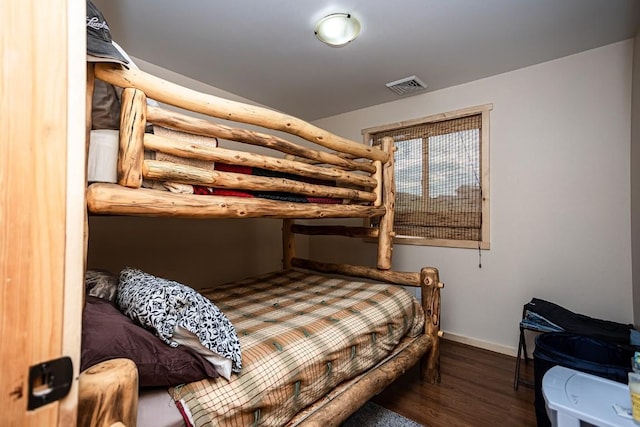420 County Road 64, Craig, CO 81625 - bedroom with log walls, visible vents, wood finished floors, and baseboards