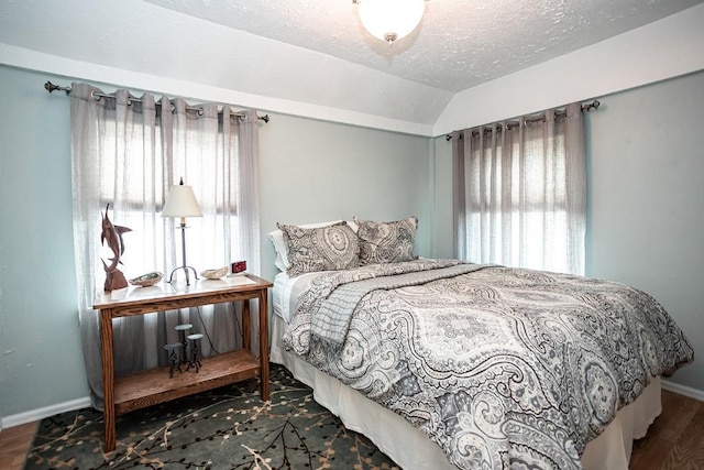 420 County Road 64, Craig, CO 81625 - bedroom featuring lofted ceiling, a textured ceiling, baseboards, and wood finished floors