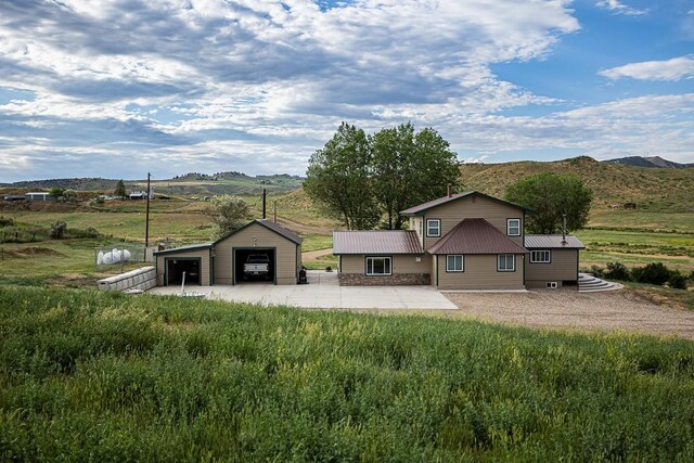 420 County Road 64, Craig, CO 81625 - exterior space featuring a mountain view, an outbuilding, metal roof, and a detached garage