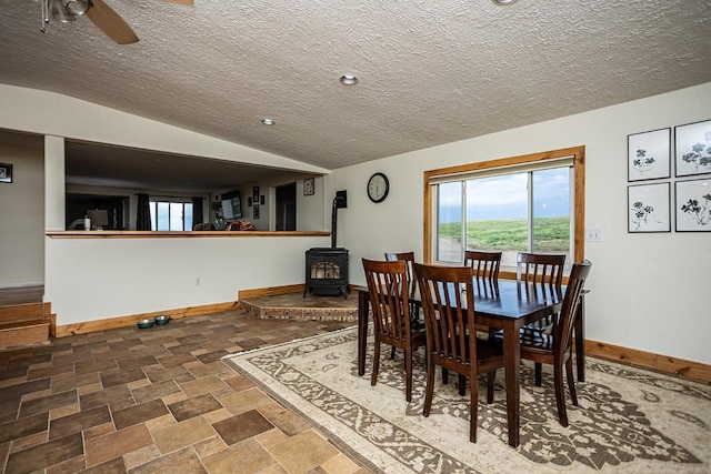 420 County Road 64, Craig, CO 81625 - dining space with a wood stove, a textured ceiling, baseboards, and a healthy amount of sunlight