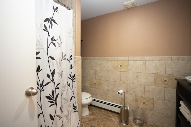 420 County Road 64, Craig, CO 81625 - bathroom featuring tile walls, tile patterned floors, toilet, and a baseboard heating unit