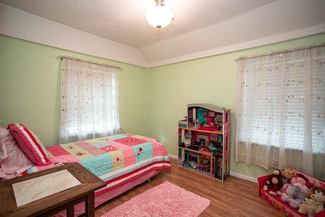 420 County Road 64, Craig, CO 81625 - bedroom with baseboards, vaulted ceiling, a textured ceiling, and wood finished floors
