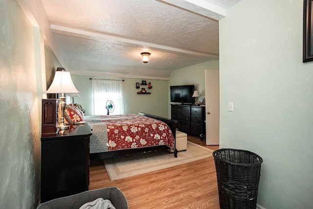 420 County Road 64, Craig, CO 81625 - bedroom featuring a textured ceiling, wood finished floors, and lofted ceiling
