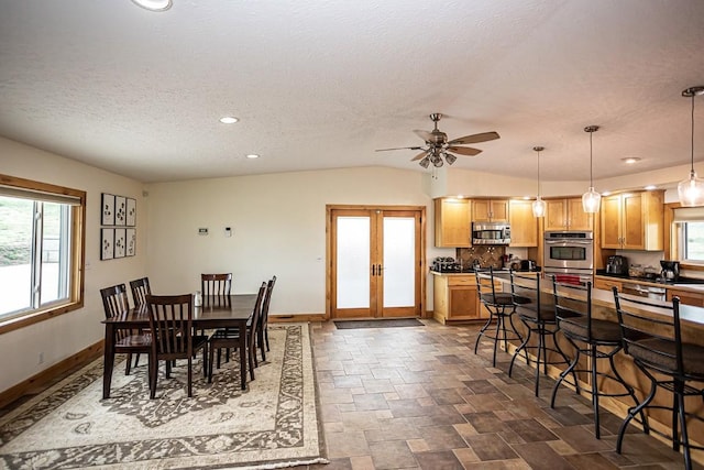 420 County Road 64, Craig, CO 81625 - dining room with french doors, stone finish floor, a textured ceiling, baseboards, and ceiling fan