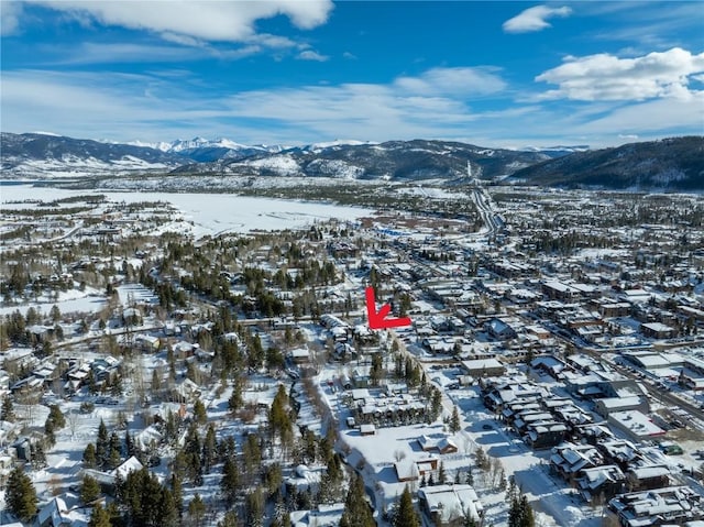 snowy aerial view featuring a mountain view