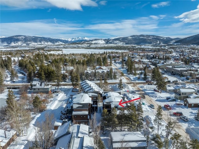 snowy aerial view with a mountain view