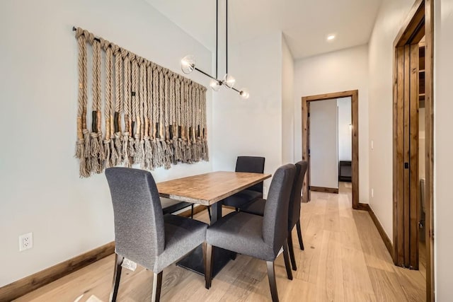 dining room featuring a chandelier and light hardwood / wood-style flooring