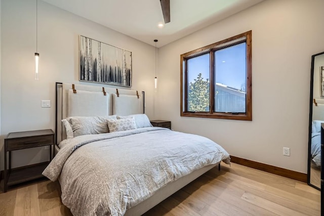 bedroom featuring light hardwood / wood-style flooring and ceiling fan