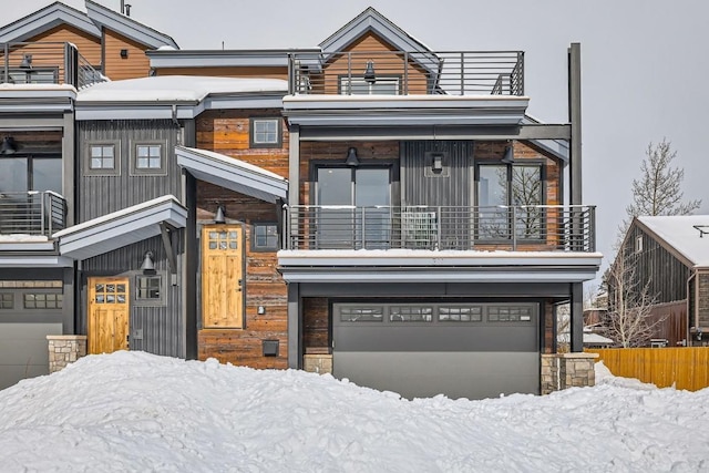 view of front of property featuring a balcony and a garage