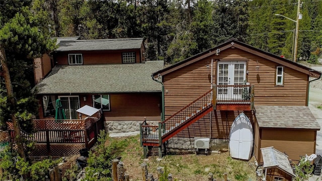 14 Rock Springs Rd, Breckenridge, CO 80424 - rear view of property with a wooden deck, a shingled roof, ac unit, stairs, and a view of trees