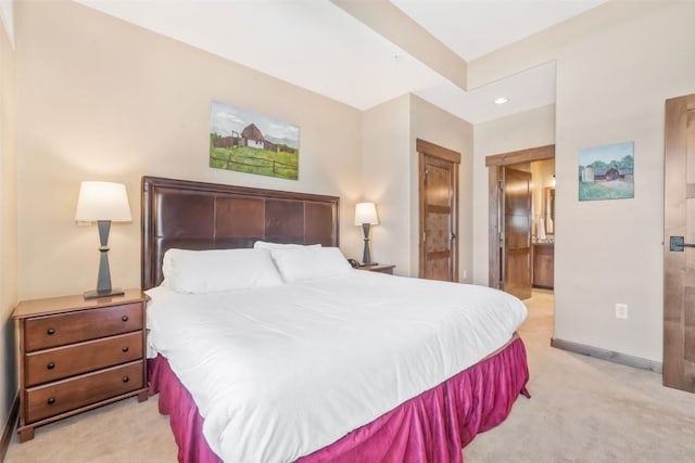 bedroom with baseboards, ensuite bath, recessed lighting, and light colored carpet