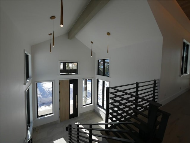 entryway with beamed ceiling and high vaulted ceiling