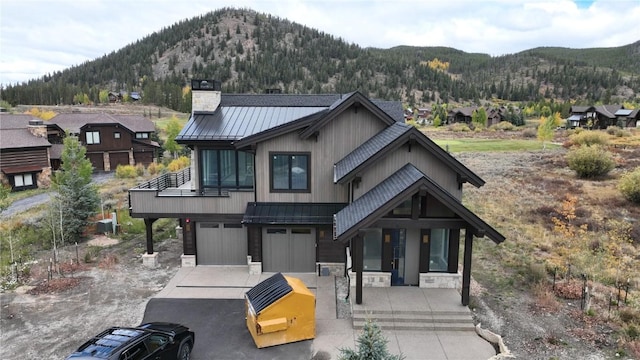 view of front of house featuring a mountain view and a garage