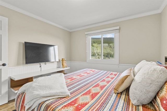 67 Peaks View Ct Unit 232, Blue River, CO 80424 - bedroom featuring ornamental molding, a wainscoted wall, and wood finished floors