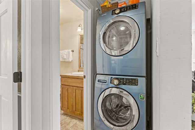 67 Peaks View Ct Unit 232, Blue River, CO 80424 - laundry room featuring stacked washing machine and dryer and light tile patterned floors