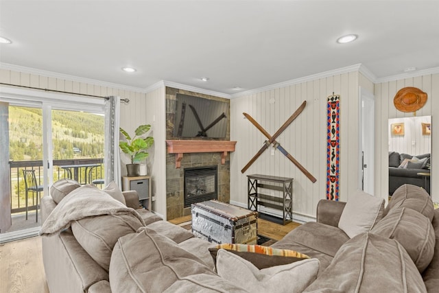 67 Peaks View Ct Unit 232, Blue River, CO 80424 - living area with crown molding, wood finished floors, a tile fireplace, recessed lighting, and a baseboard heating unit