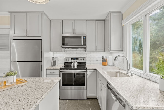 67 Peaks View Ct Unit 232, Blue River, CO 80424 - kitchen featuring appliances with stainless steel finishes, gray cabinets, tasteful backsplash, and light stone countertops