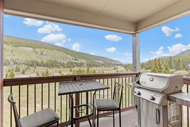 67 Peaks View Ct Unit 232, Blue River, CO 80424 - balcony with a grill, a mountain view, and a view of trees