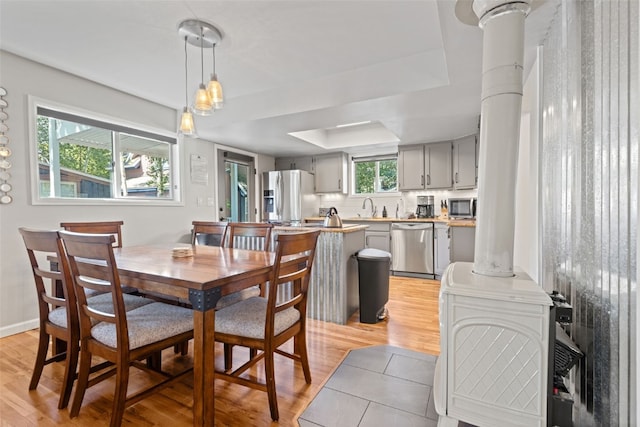 211 S High St, Breckenridge, CO 80424 - dining area with a raised ceiling, baseboards, light wood finished floors, and decorative columns