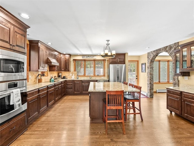 50 Sunset Dr, Breckenridge, CO 80424 - kitchen featuring stainless steel appliances, a chandelier, wood finished floors, a kitchen bar, and recessed lighting