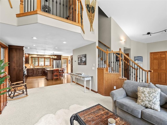 50 Sunset Dr, Breckenridge, CO 80424 - living room featuring stairway, a towering ceiling, recessed lighting, a chandelier, and wood finished floors