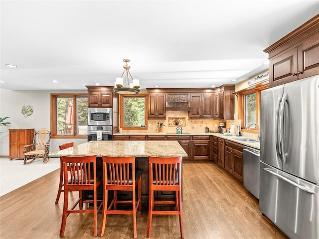 50 Sunset Dr, Breckenridge, CO 80424 - kitchen with stainless steel appliances, exhaust hood, light wood-style floors, a kitchen island, and recessed lighting
