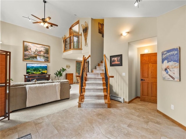 50 Sunset Dr, Breckenridge, CO 80424 - living room with baseboard heating, stairs, a ceiling fan, and high vaulted ceiling
