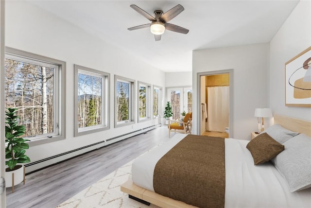 bedroom featuring ceiling fan, light wood-type flooring, baseboard heating, and multiple windows