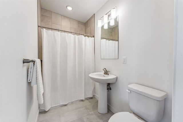 bathroom with a shower with shower curtain and toilet