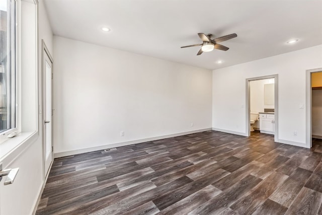 unfurnished bedroom with ensuite bathroom, ceiling fan, and dark hardwood / wood-style floors