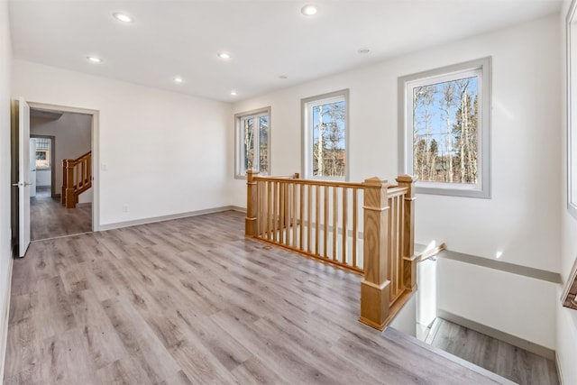 hallway with light hardwood / wood-style flooring