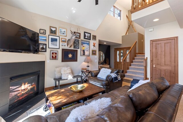 73 Chestnut Ln Unit 73, Breckenridge, CO 80424 - living area with a glass covered fireplace, a towering ceiling, and stairway