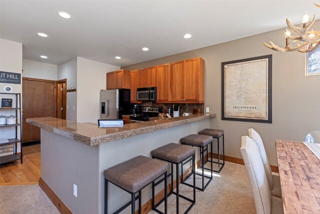 73 Chestnut Ln Unit 73, Breckenridge, CO 80424 - kitchen featuring recessed lighting, light carpet, stainless steel appliances, and a peninsula