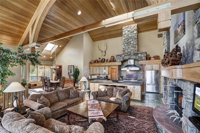 348 Jade Rd, Silverthorne, CO 80498 - living area with wood ceiling with exposed beams, a glass covered fireplace, high vaulted ceiling, and stone tile floors