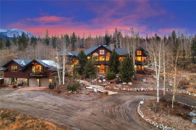348 Jade Rd, Silverthorne, CO 80498 - view of front facade with curved driveway, a garage, and a chimney