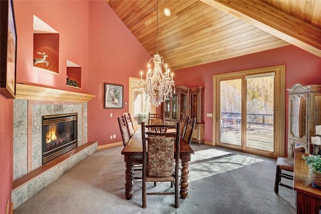 348 Jade Rd, Silverthorne, CO 80498 - carpeted dining area with wood ceiling, healthy amount of natural light, a chandelier, a premium fireplace, and baseboards